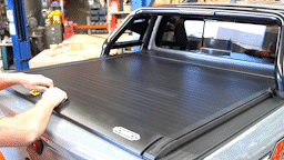 4x4 truck bed showing a manual roller tonneau cover or a lockable roller ute tray cover